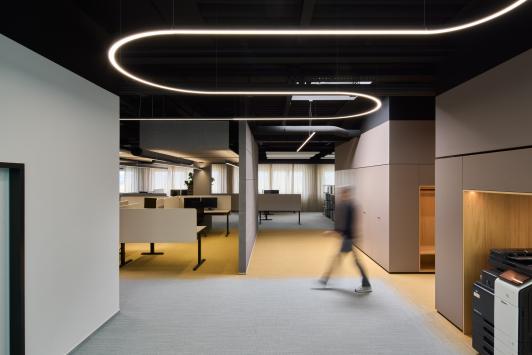 Arbeitswelt im Bürogebäude der Homag Group in Holzbronn mit zentraler Erschließungszone und gezielter Lichtführung, geplant von arcplus Architekten